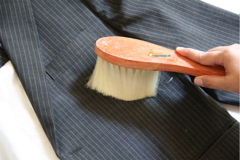 Sử dụng bàn chải mềm để vệ sinh bụi bẩn, các mảnh vụn tại các khe tay áo, cổ áo
